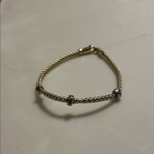 14 Kt yellow gold and white gold braided Women's Bracelet with diamonds